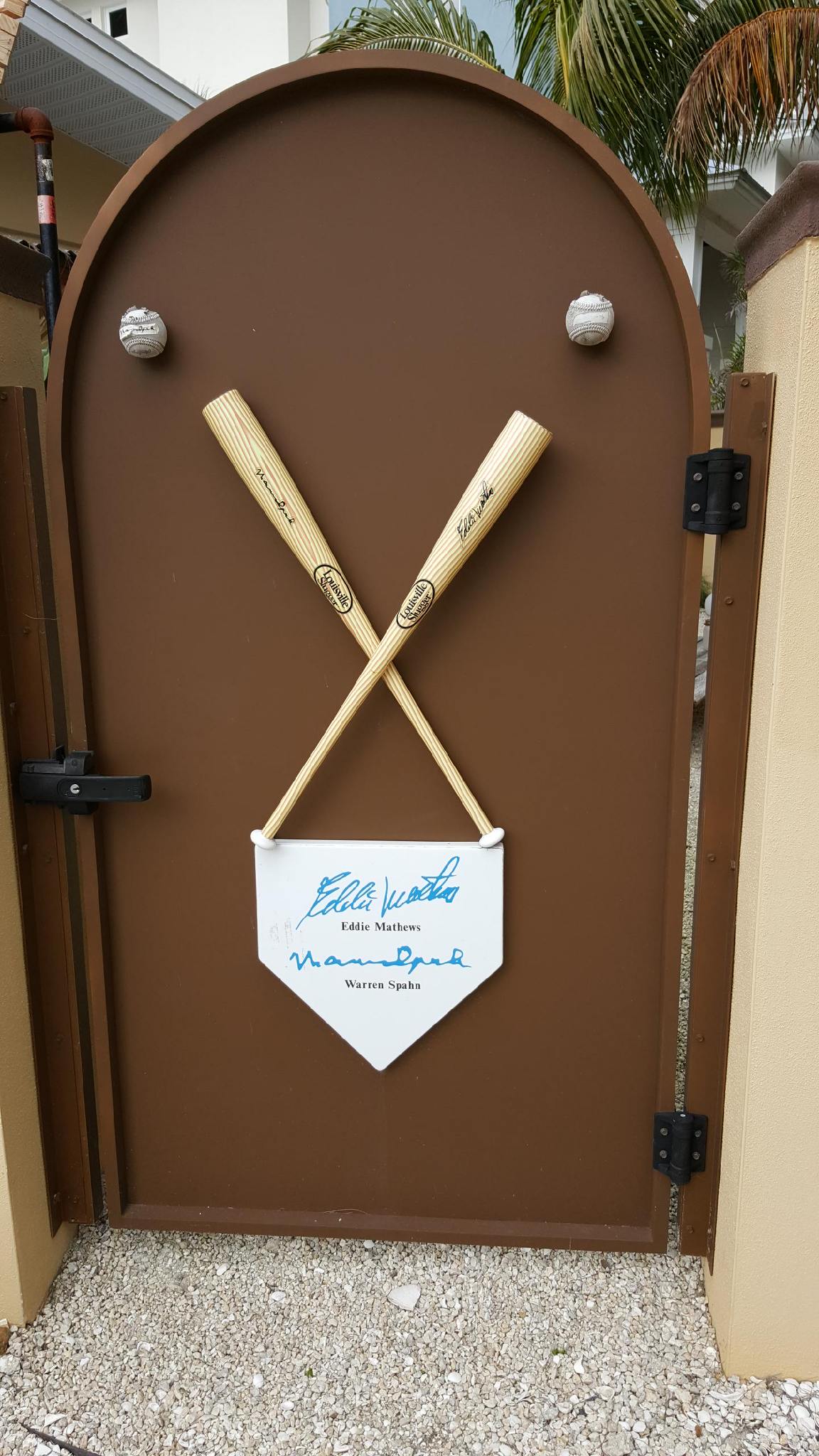 A gate with bats and autographs of Eddie Mathews and Warren Spahn